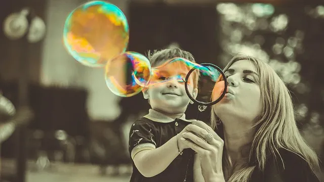 things to do on a rainy day kid blowing bubbles with mother