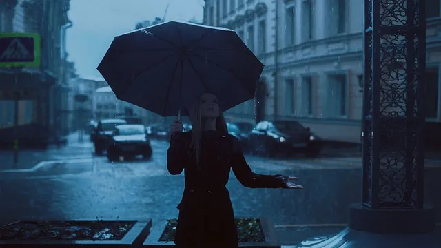 things to do on a rainy day woman going for walk with umbrella